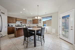 Dining space with a chandelier and light tile patterned flooring