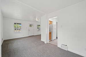 Spare room featuring light colored carpet and a textured ceiling