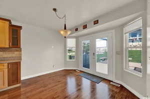 Doorway to outside featuring french doors and dark hardwood / wood-style flooring