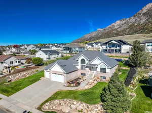 View of front of property with a mountain view and a garage