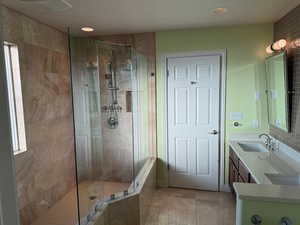 Master Bathroom featuring vanity and a tile shower