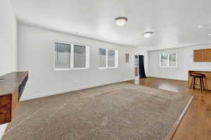 Living room featuring a textured ceiling and hardwood / wood-style floors