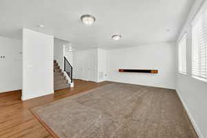 Unfurnished living room with a textured ceiling and wood-type flooring