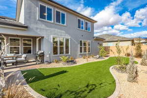 Rear view of house with a yard and a patio area