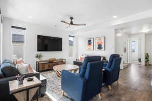 Living room with ceiling fan and dark hardwood / wood-style floors