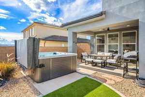 View of patio / terrace featuring a hot tub, ceiling fan, and outdoor lounge area