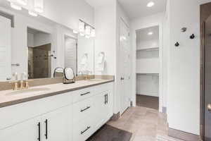 Bathroom featuring walk in shower and vanity