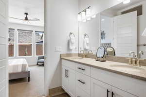 Bathroom with tile patterned flooring, ceiling fan, and vanity