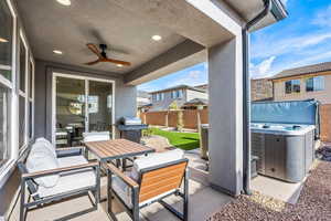 View of patio / terrace featuring outdoor lounge area, grilling area, ceiling fan, and a hot tub