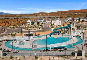 View of pool featuring a mountain view, a water slide, and a patio area