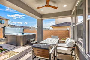 View of patio with ceiling fan, central AC, and a hot tub