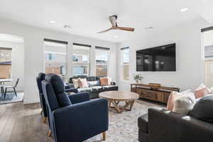 Living room featuring ceiling fan and hardwood / wood-style floors