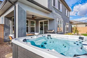 View spa with back patio with ceiling fan and a hot tub