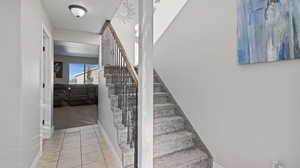 Stairway featuring tile patterned floors