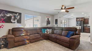 Living room featuring ceiling fan and light tile patterned flooring