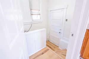 Interior space featuring hardwood / wood-style floors and radiator heating unit