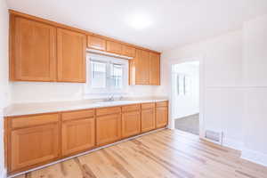 Kitchen with light wood-type flooring and sink