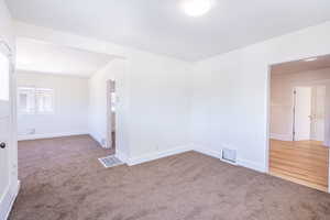 Spare room featuring carpet flooring