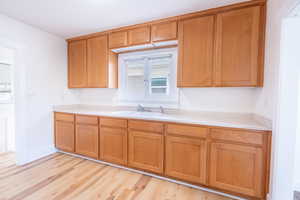 Kitchen featuring light wood-type flooring and sink