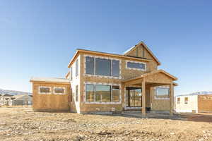 Back of property with a mountain view