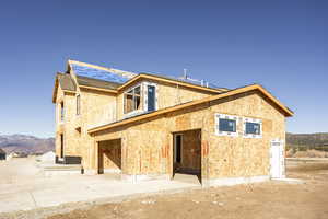 Rear view of house with a patio and a mountain view