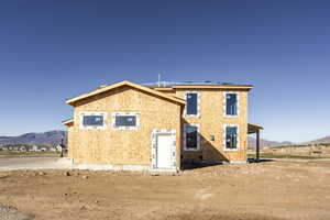 Back of house featuring a mountain view