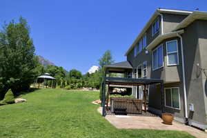 View of yard with a patio area, a mountain view, a pergola, and a gazebo