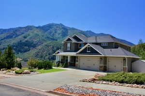 View of front of property with a mountain view and a garage