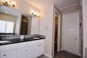 The main bath includes a private water closet, vanity with double sinks, and granite countertop.Tub and shower.