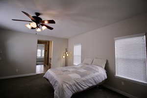 Bedroom with ceiling fan and carpet