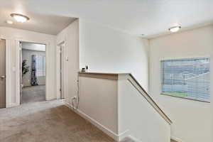 Hallway upstairs to 4 bedrooms, laundry room, and full bathroom