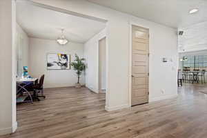 Inside entry way with office on one side and living room/formal dining area on the other side.