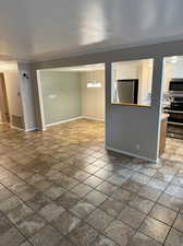 Front room and dining area featuring an inviting chandelier and ornamental molding