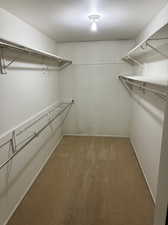 Spacious master closet with carpet floors