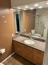 Master bathroom featuring a shower with shower door, vanity, and toilet