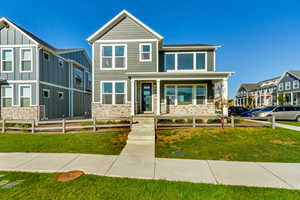 View of front of property featuring a porch and a front lawn