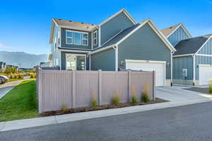 View of backyard, garage, and side of home