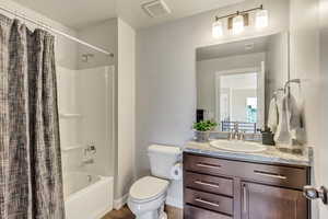 Full bathroom with vanity, toilet, and a shower / bath combo