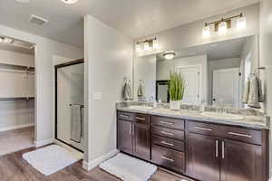 Master bathroom with vanity, a textured ceiling, and an enclosed shower