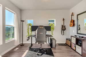 Office with large windows, natural light, and mountain/pool views