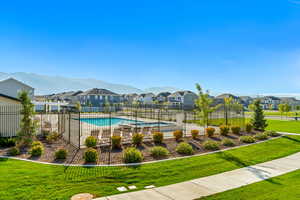 Directly across from the community swimming pool, pickleball courts, and grass area