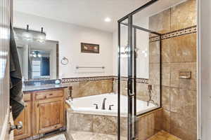 Bathroom with vanity and separate shower and tub