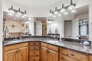 Bathroom with ceiling fan and vanity