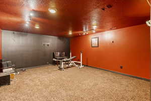 Interior space featuring a textured ceiling and track lighting