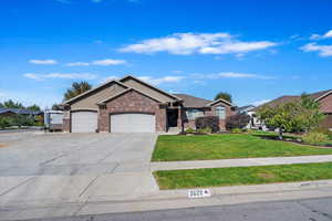 Single story home with a front lawn and a garage