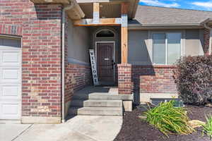 View of exterior entry featuring a garage