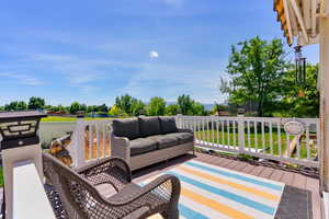 Deck with an outdoor hangout area and a yard