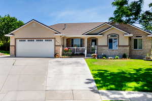 View of front facade featuring a garage and a front yard