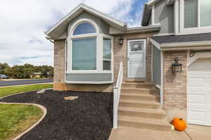 View of exterior entry featuring a garage