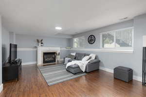 Living room featuring a fireplace and dark wood-type flooring